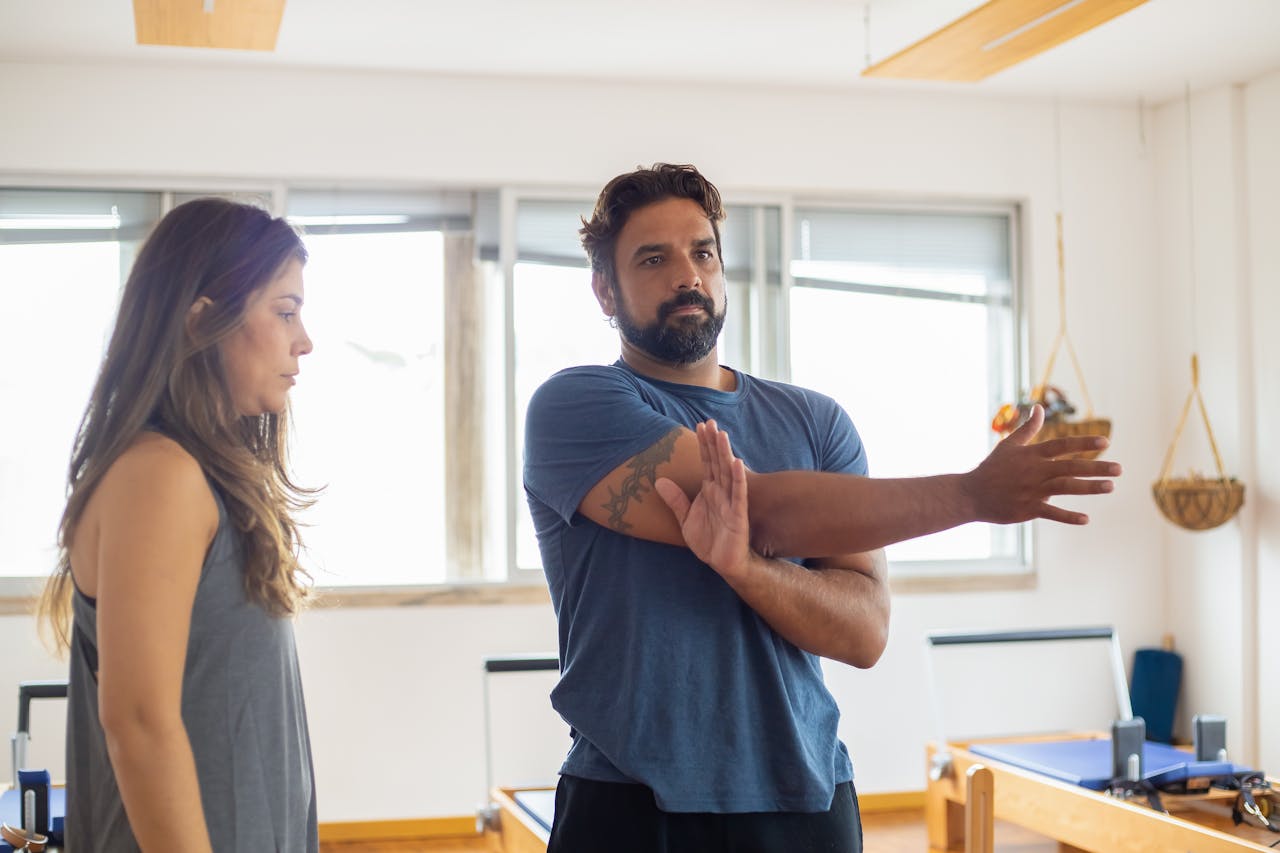 A Woman Supervising a Man's Exercise
